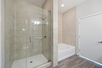 a bathroom with tiled walls and a glass shower stall